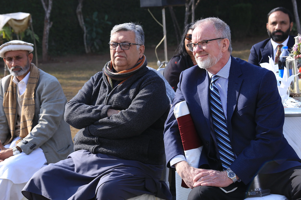 J.P. Knight seated with friends at an outdoor gathering
