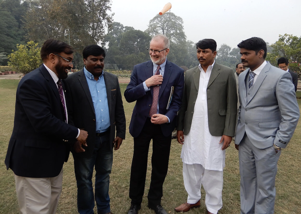 J.P. Knight in conversation with a group of men